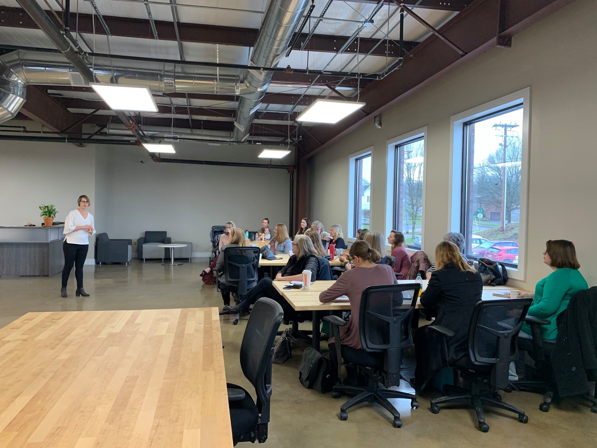 Image of another Sky City workshop in the main area with groups sitting at the tables