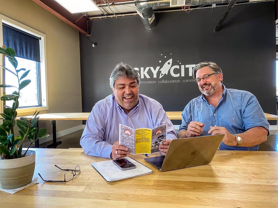 Image of two Sky City members collaborating and having a great time swapping ideas!